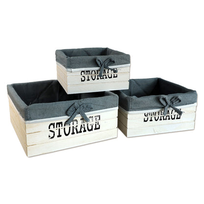 aufbewahrungskörbe aus weißem holz mit der aufschrift storage und mit grauer leinenstoffeinlage. 3er set in drei unterschiedlichen größen, rechteckig ohne deckel