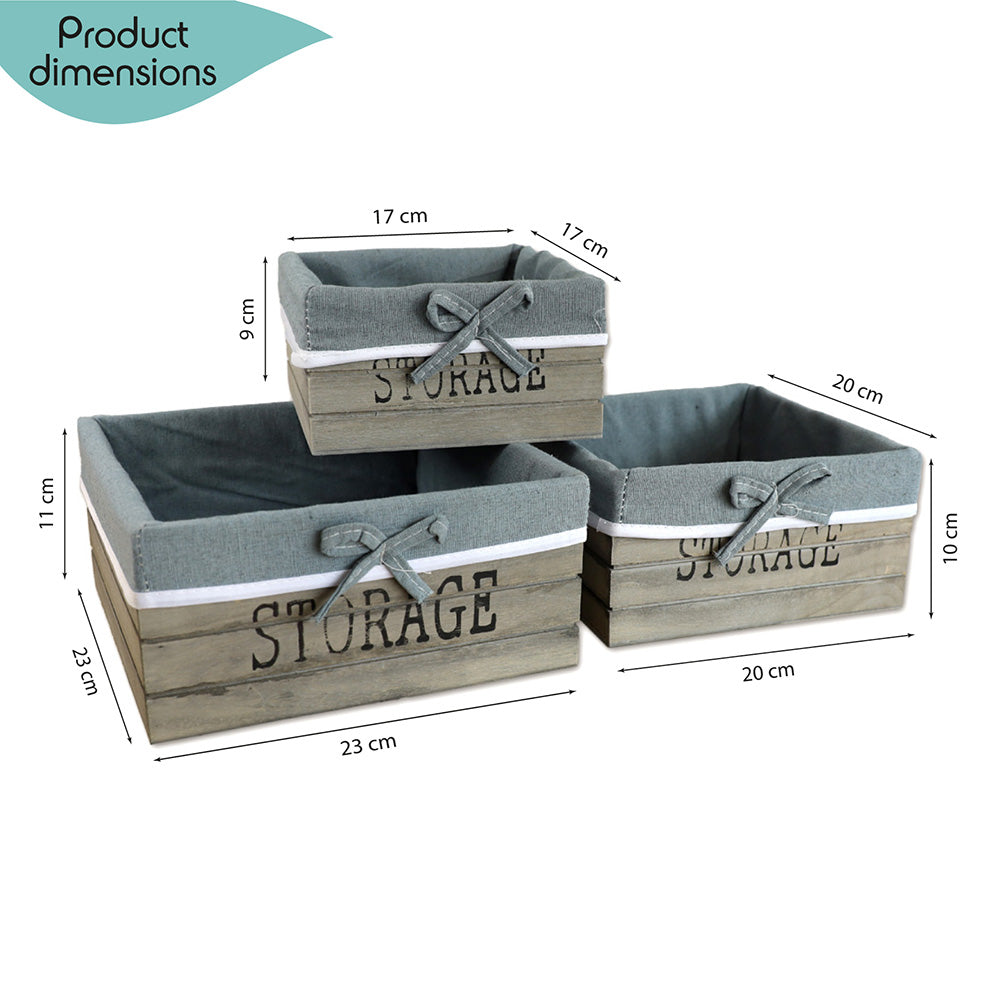 aufbewahrungskörbe aus braunem holz mit der aufschrift storage und mit grauer leinenstoffeinlage. 3er set in drei unterschiedlichen größen, rechteckig ohne deckel