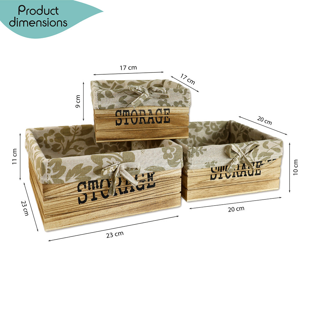 aufbewahrungskörbe aus braunem holz mit der aufschrift storage und mit beige gemusterter leinenstoffeinlage. 3er set in drei unterschiedlichen größen, rechteckig ohne deckel