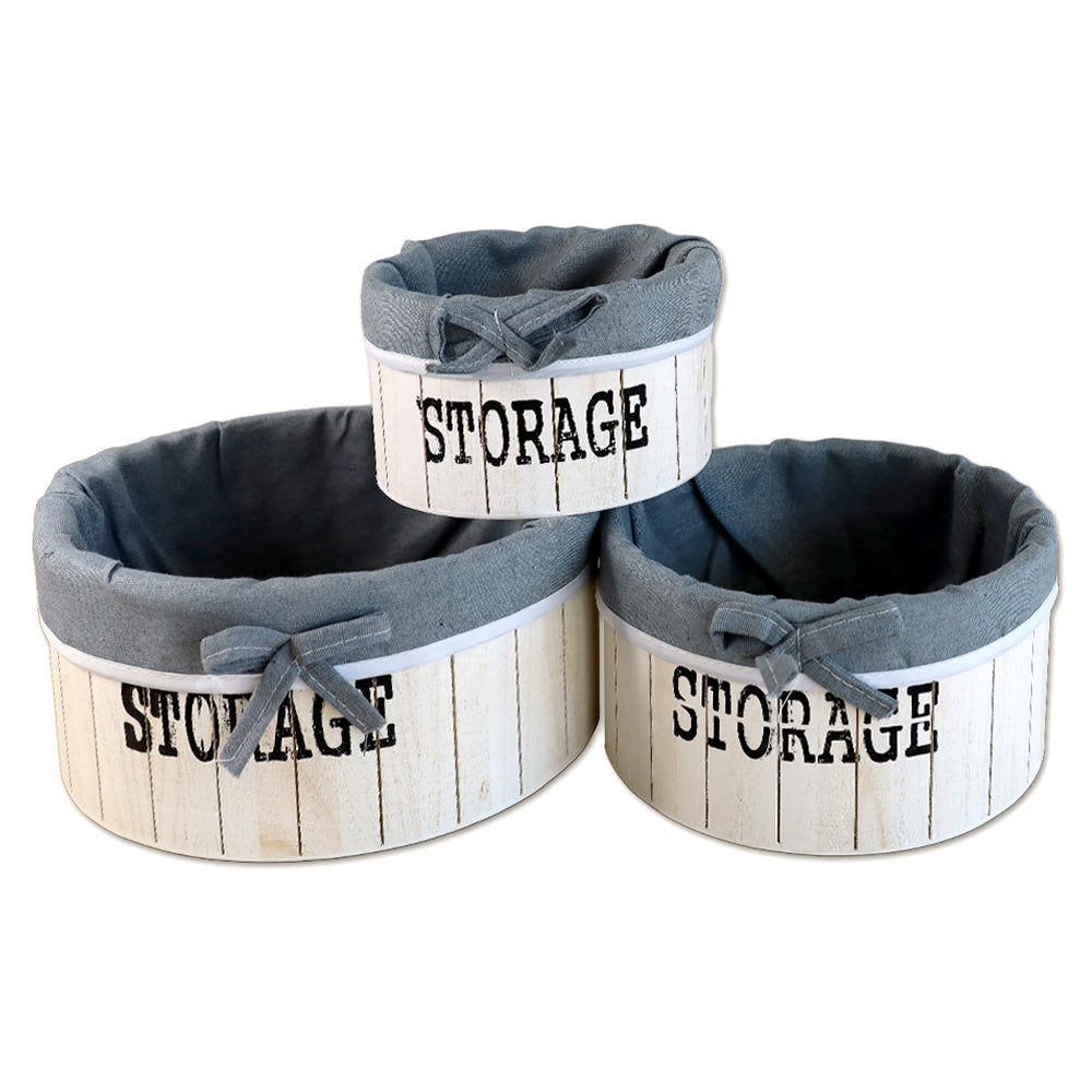 aufbewahrungskörbe aus weißem holz mit der aufschrift storage und mit grauer leinenstoffeinlage. 3er set in drei unterschiedlichen größen, rund ohne deckel