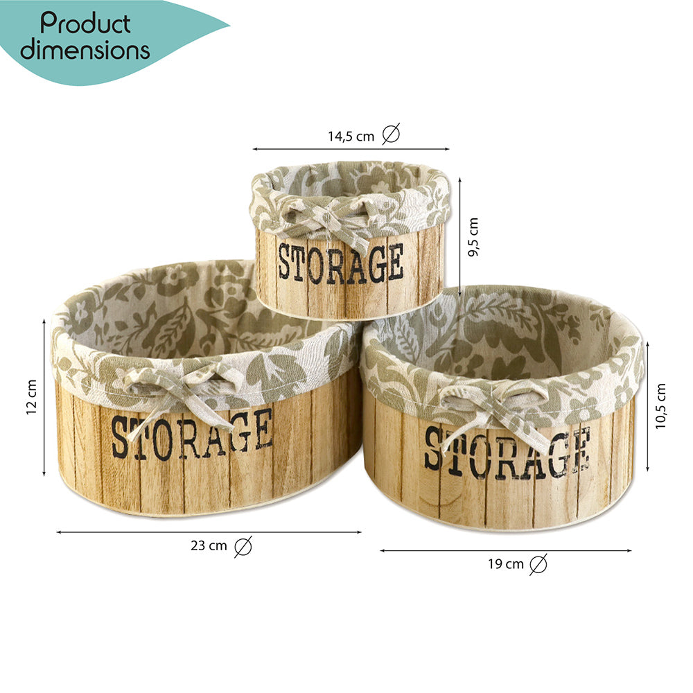 aufbewahrungskörbe aus hellbraunem holz mit der aufschrift storage und mit beige gemusterter leinenstoffeinlage. 3er set in drei unterschiedlichen größen, rund ohne deckel